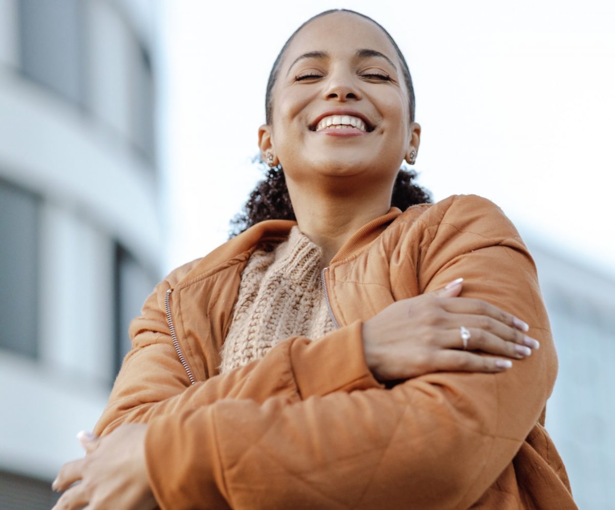 A therapist hugs herself, practicing self compassion